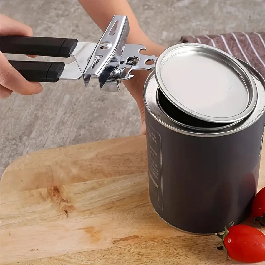 Can opener with ergonomic grip opening a can